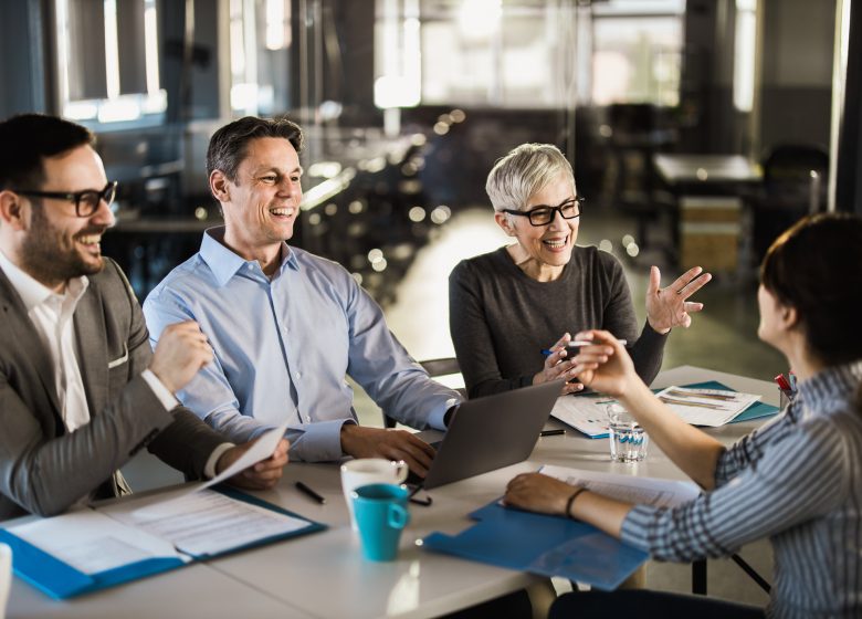 Happy business team talking to their candidate on a job interview in the office.